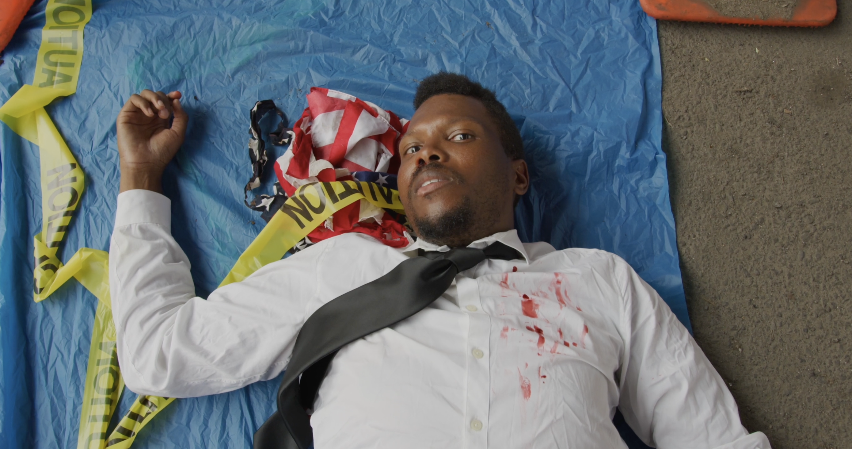 D!SoRd3rEd — man lying on blue tarp