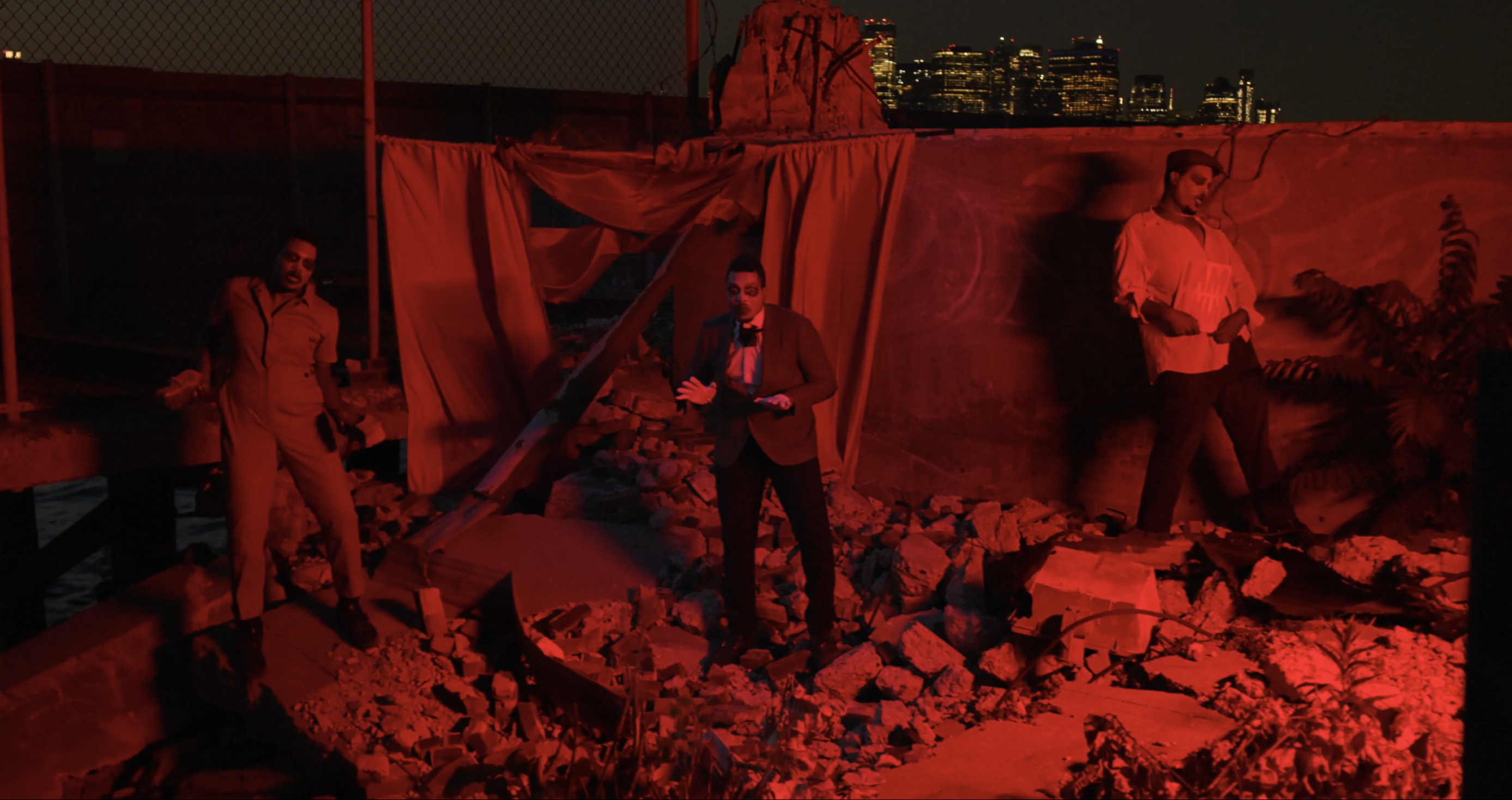 D!SoRd3rEd — red-lit three men on rocks